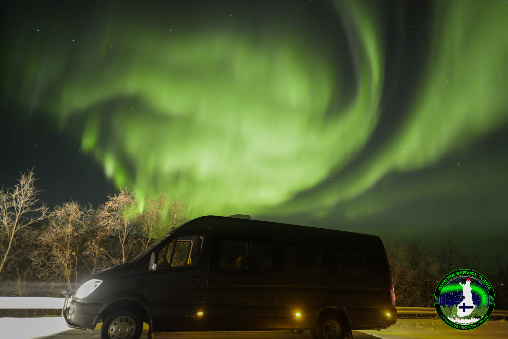Aurora chasing bus under the northern lights